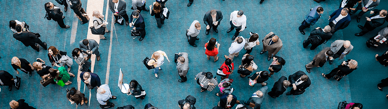 An arial view of an AMCP conference event with lots of attendees in conversation